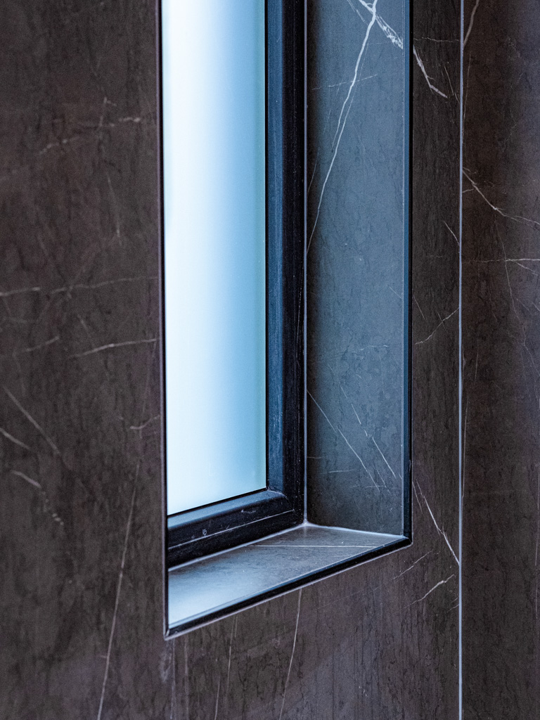 Dark marble wall with recessed niche